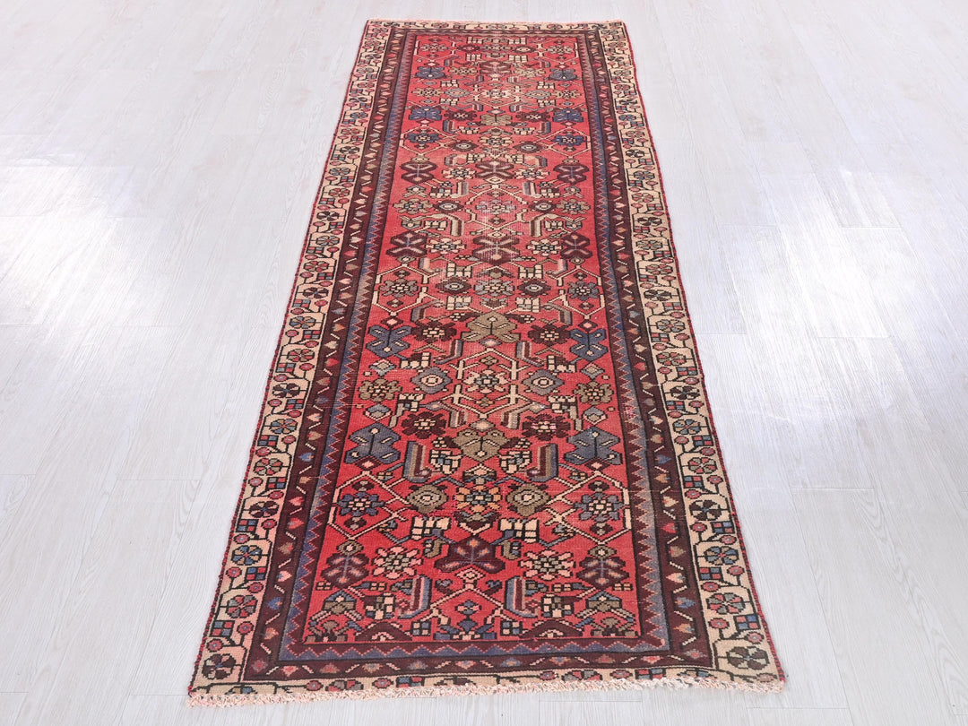 a long red rug on a white floor
