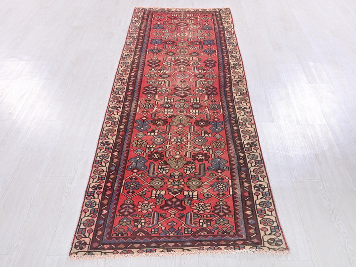 a long red rug on a white floor