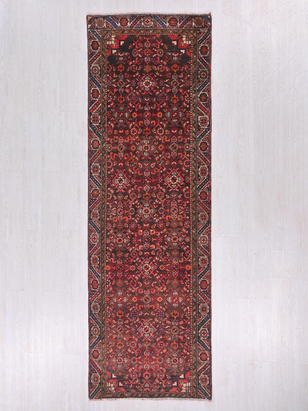 a red rug hanging up against a wall