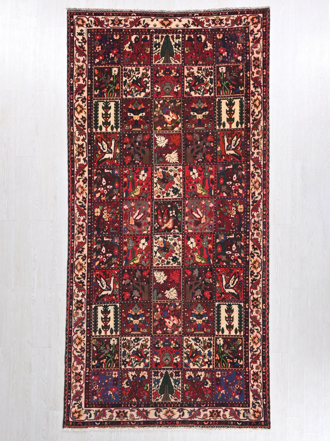 a red rug with a patchwork design on it