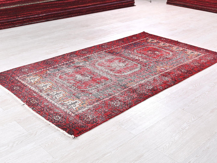 a red rug on the floor of a room