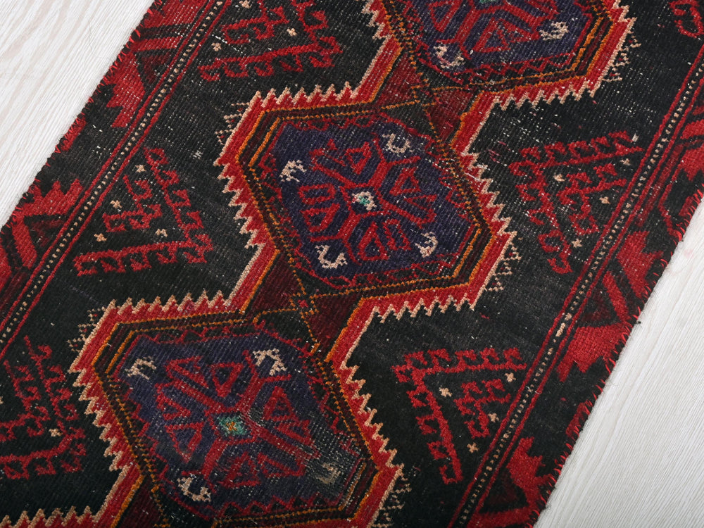 a close up of a rug on a wooden floor