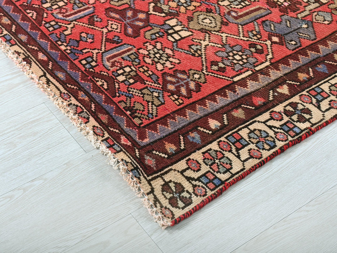 a red and blue rug on a white floor