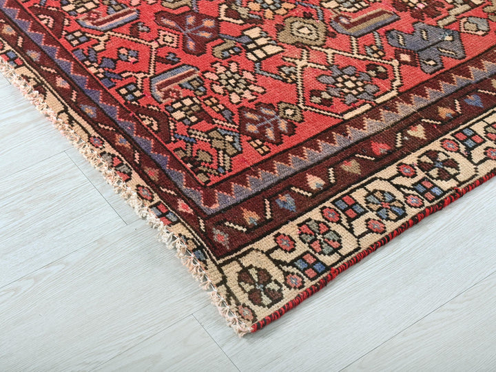 a red and blue rug on a white floor
