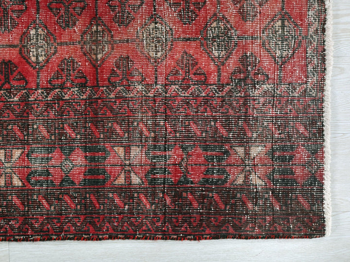 a red and black rug with a pattern on it