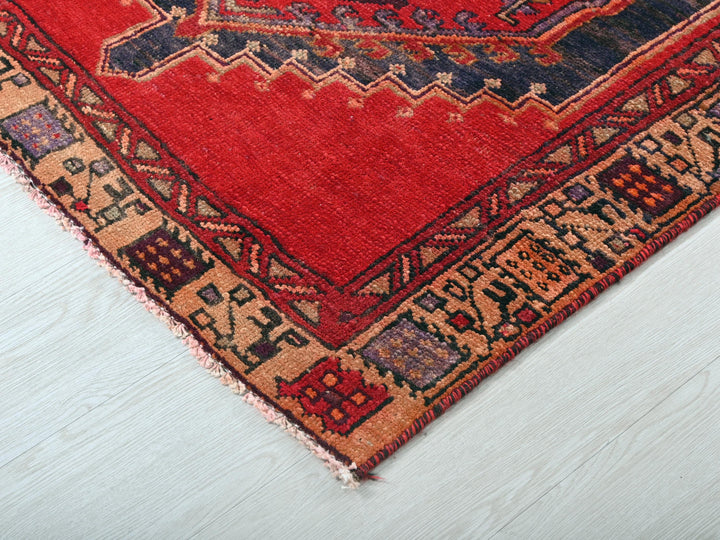 a red rug on a white wooden floor