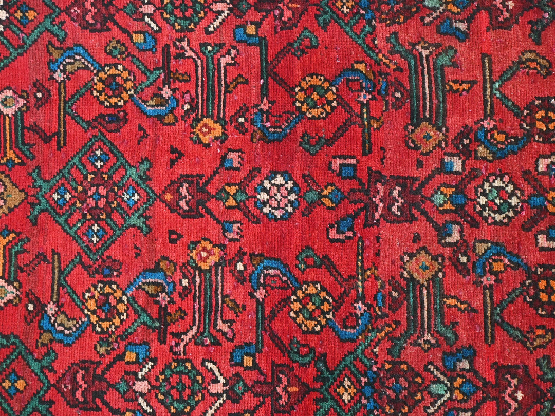 a red rug with many different designs on it