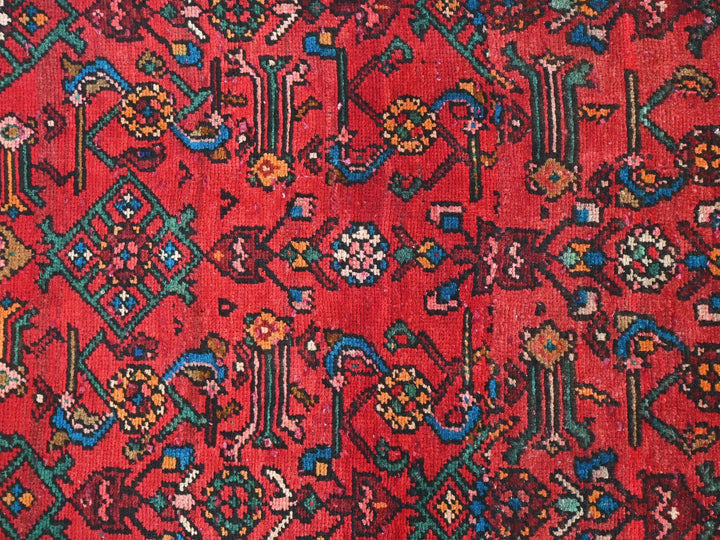 a red rug with many different designs on it