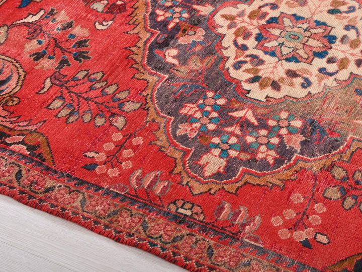 a red rug with a floral design on it