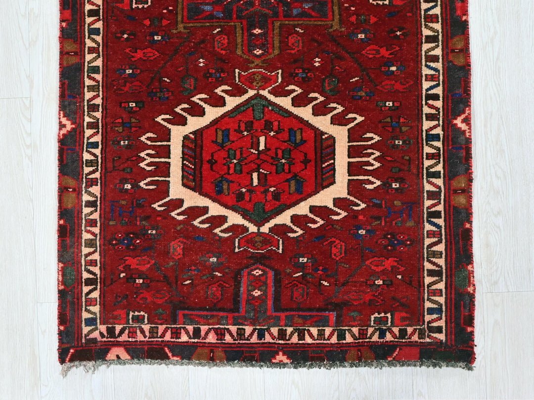 a red rug with an intricate design on it