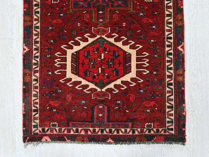 a red rug with an intricate design on it