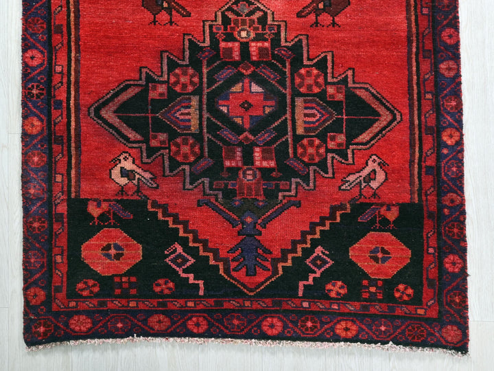 a red rug with birds on it