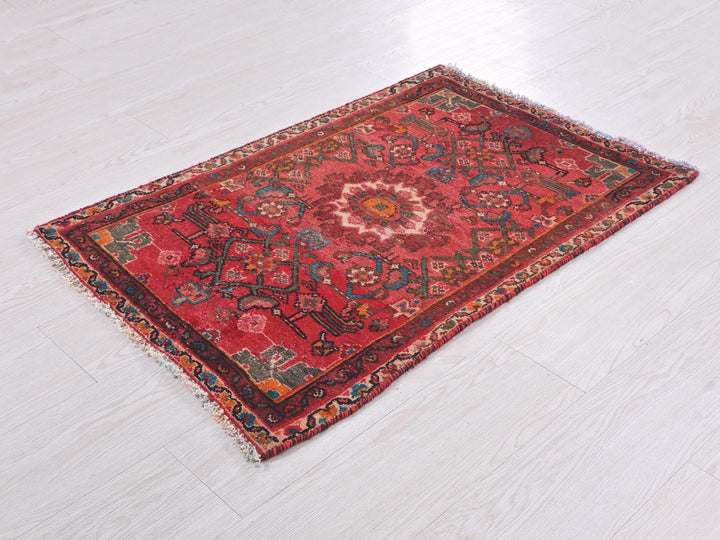 a red rug is laying on the floor