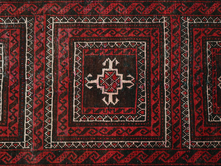 a close up of a red and black rug
