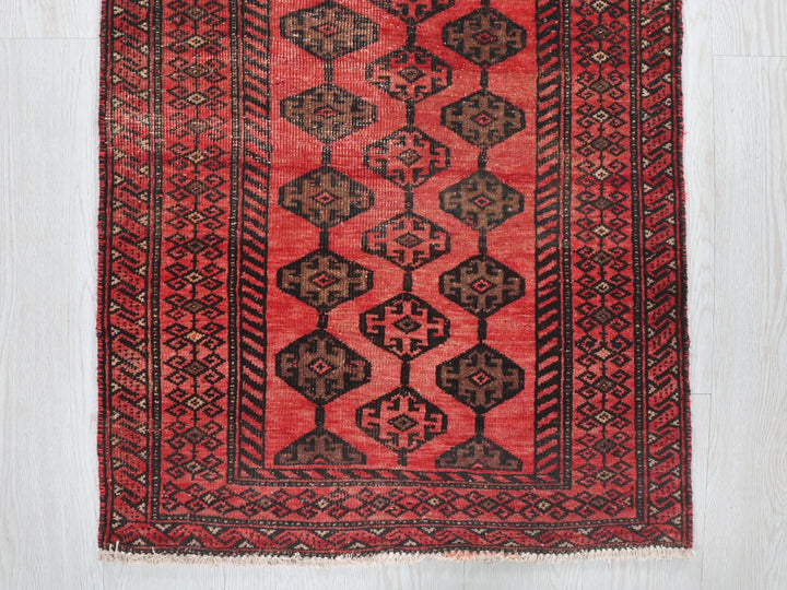 a red rug on a white wooden floor