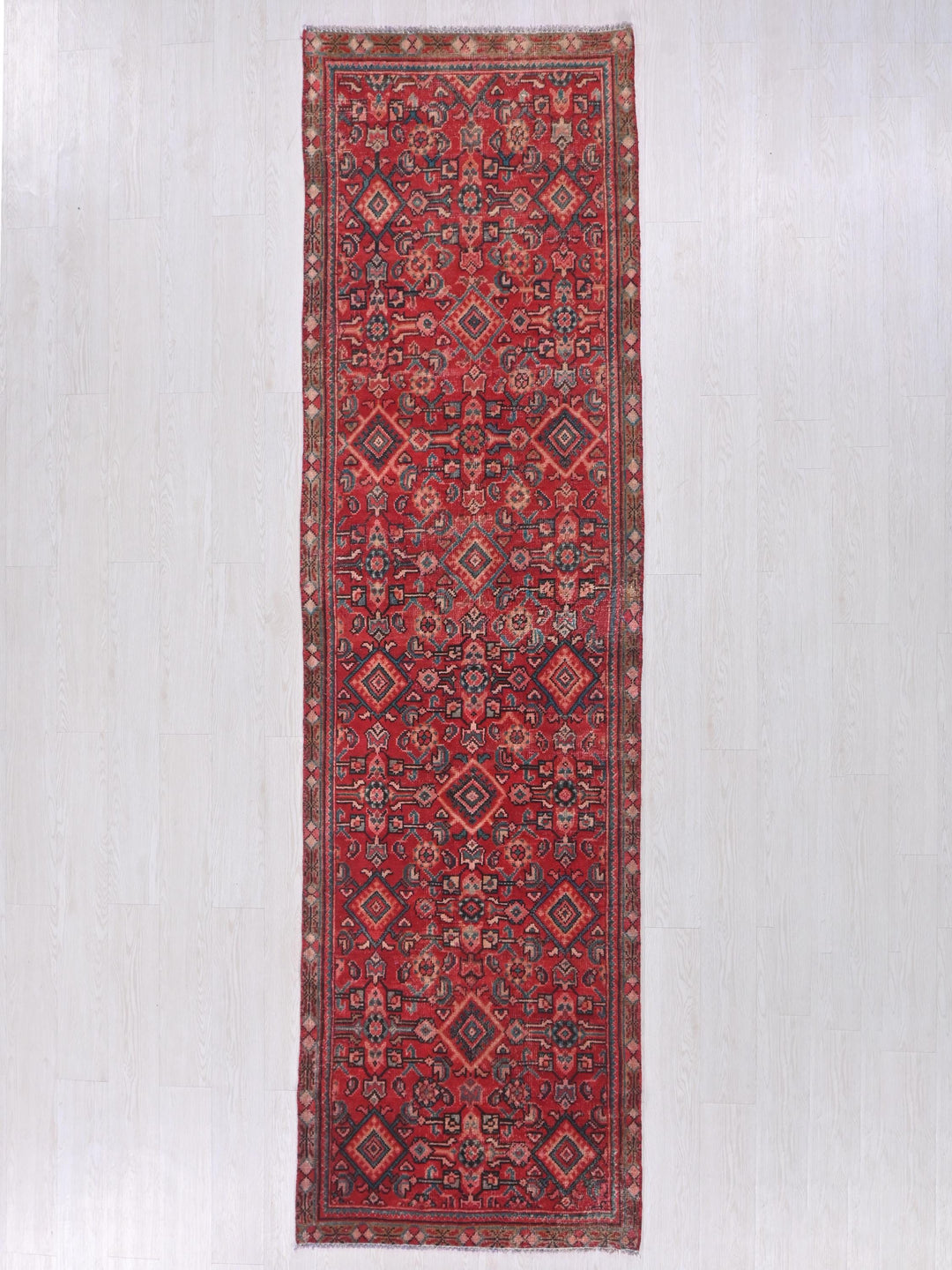 a red rug hanging up against a wall