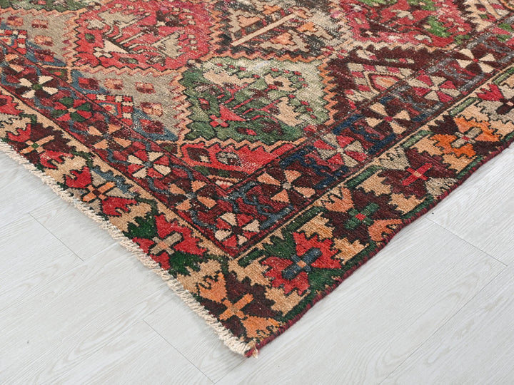 a multicolored oriental rug on a white wooden floor