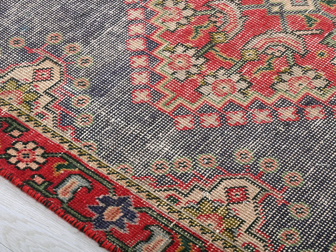 a close up of a rug on a wooden floor