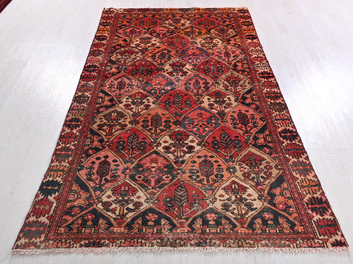 a red and black oriental rug on a white floor