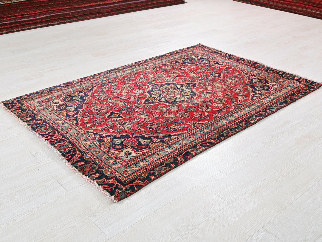 a red rug is laying on the floor