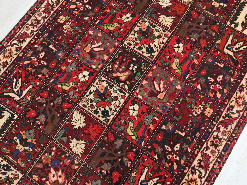 a red rug with many different designs on it
