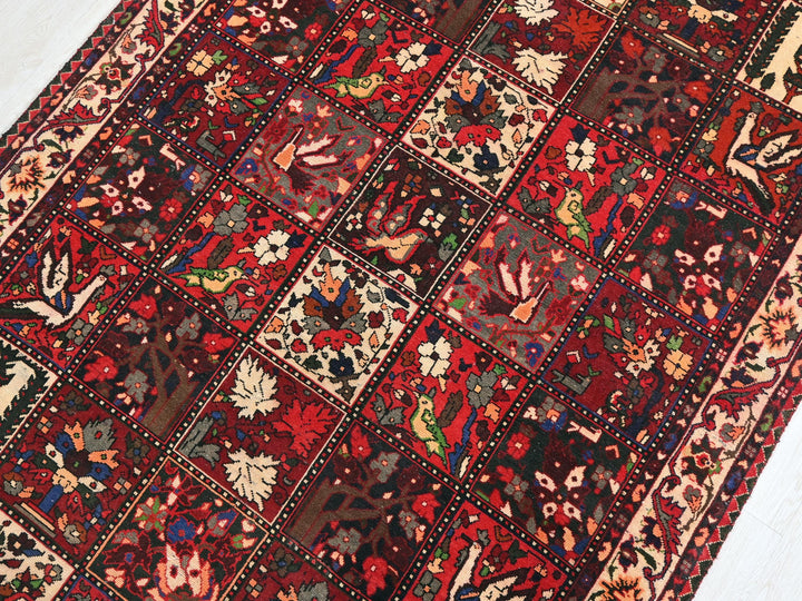 a red rug with many different designs on it