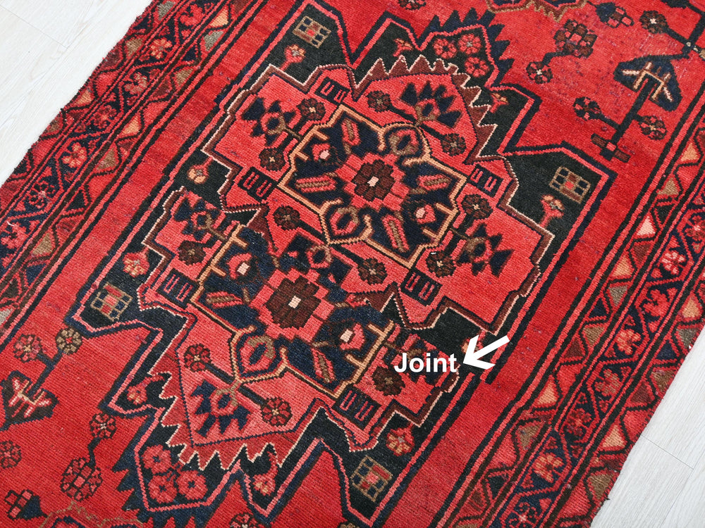 a close up of a red rug on a floor