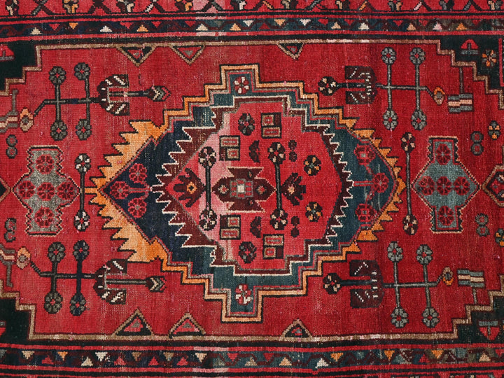 a red rug with many different designs on it