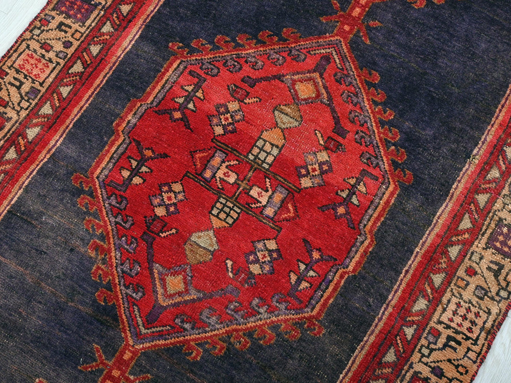 a blue and red rug with a design on it