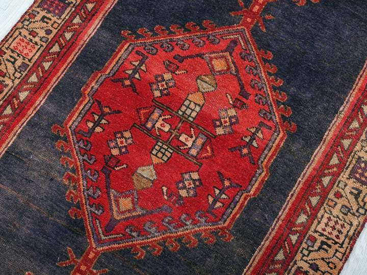 a blue and red rug with a design on it
