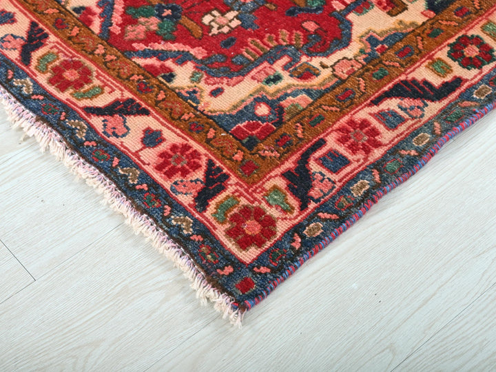 a red and blue rug on a white floor
