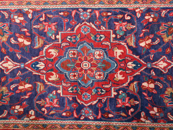 a blue and red rug with a floral design