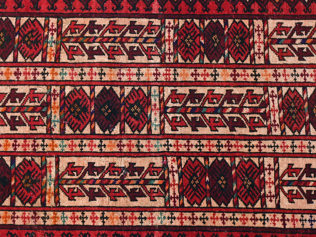 a close up of a red and black rug