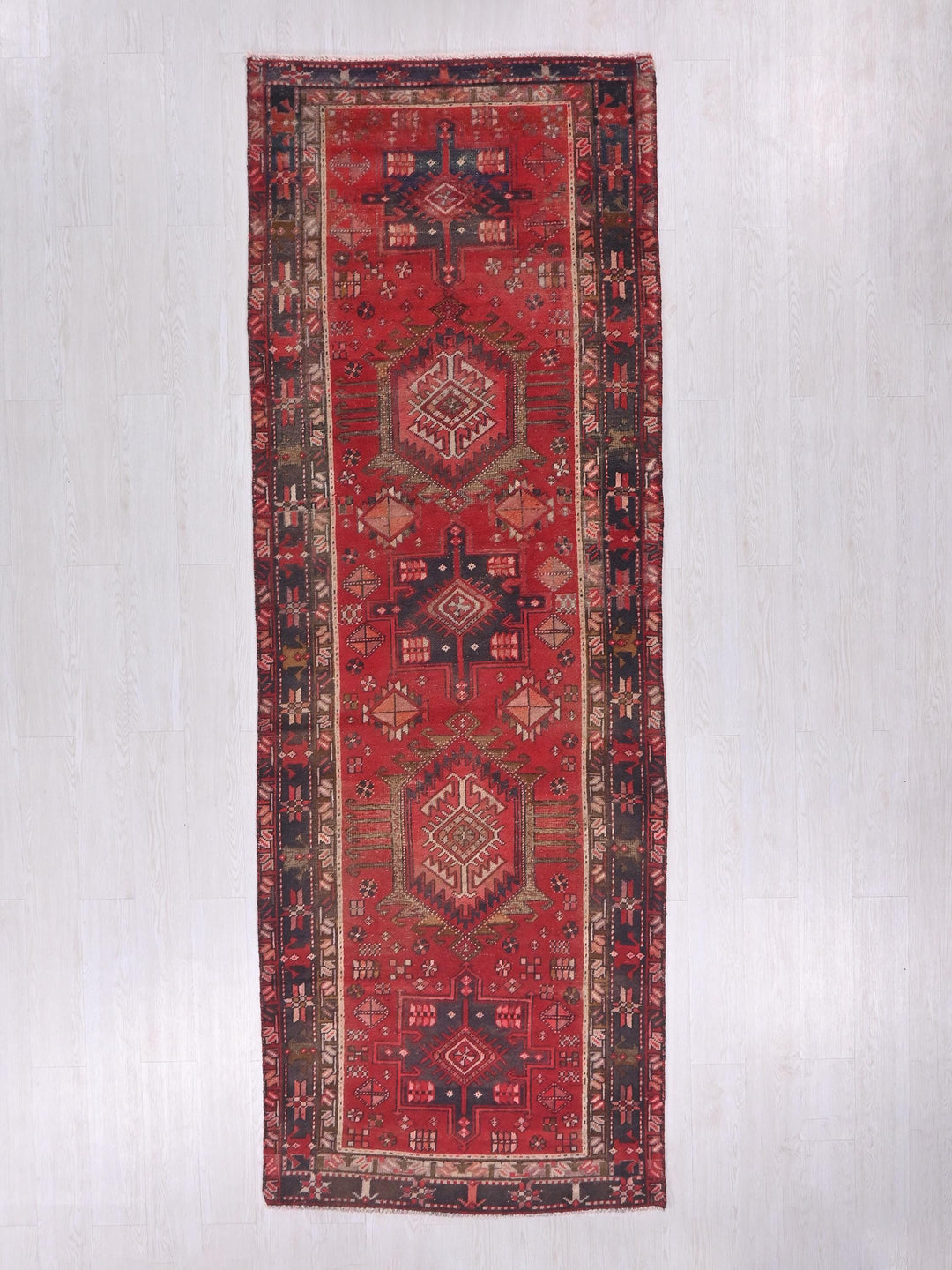 a red rug hanging up against a wall