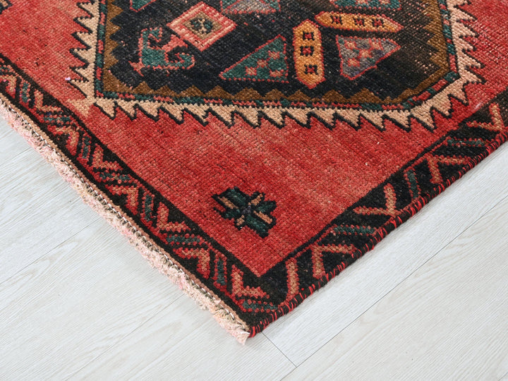 a red rug with a picture of a cat on it
