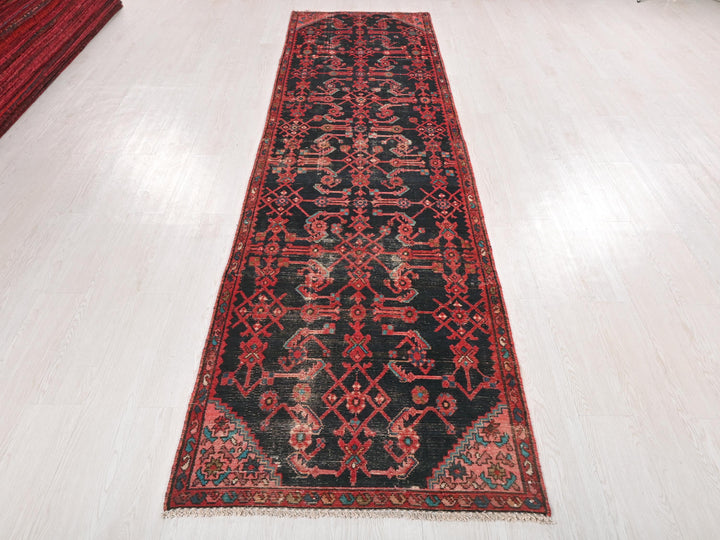 a red and black rug on a white floor
