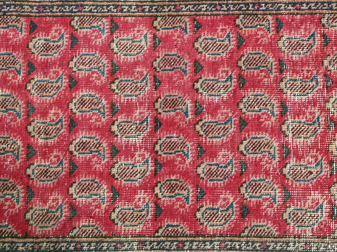 a close up of a red rug with a pattern on it