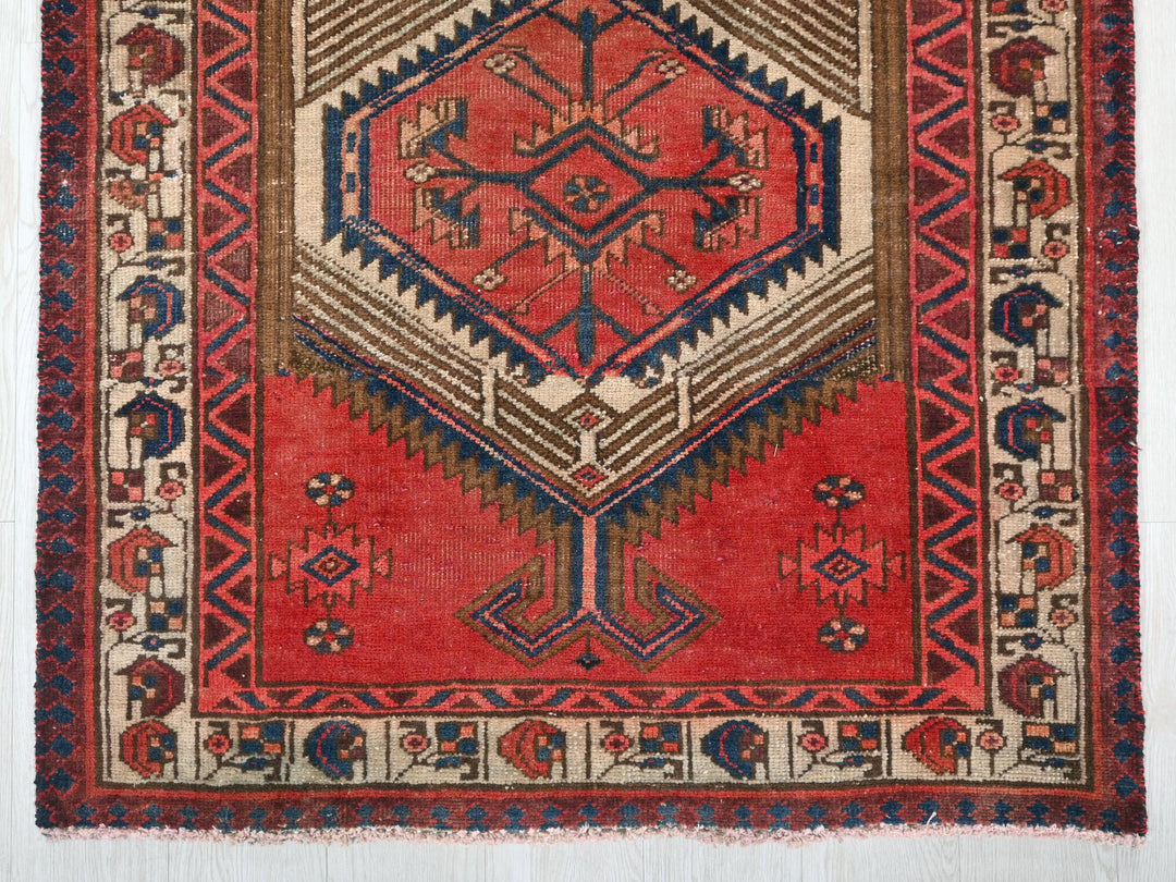 a red rug with a design on it