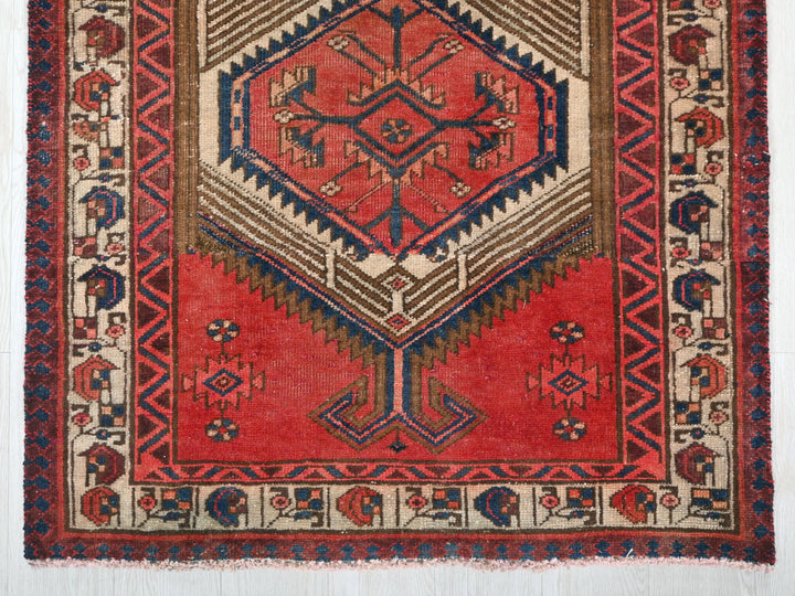 a red rug with a design on it