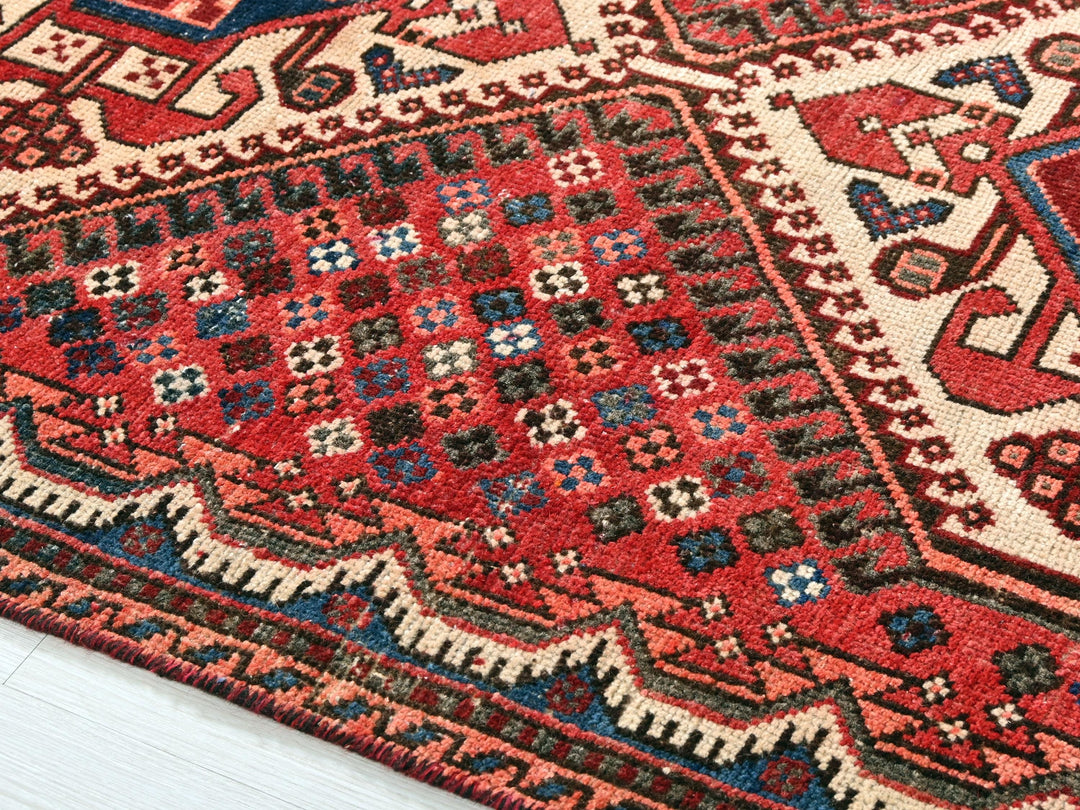 a red and blue rug on a white floor
