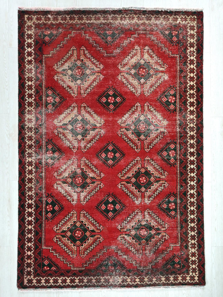 a red rug with a diamond pattern on it