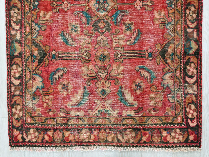 a red rug with a floral design on it