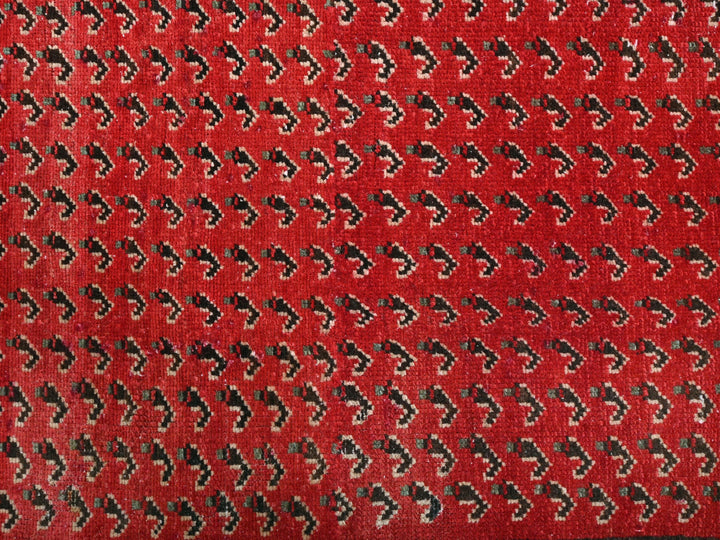 a red rug with black and white designs on it