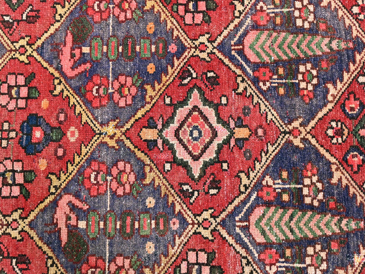 a red and blue rug with a diamond pattern
