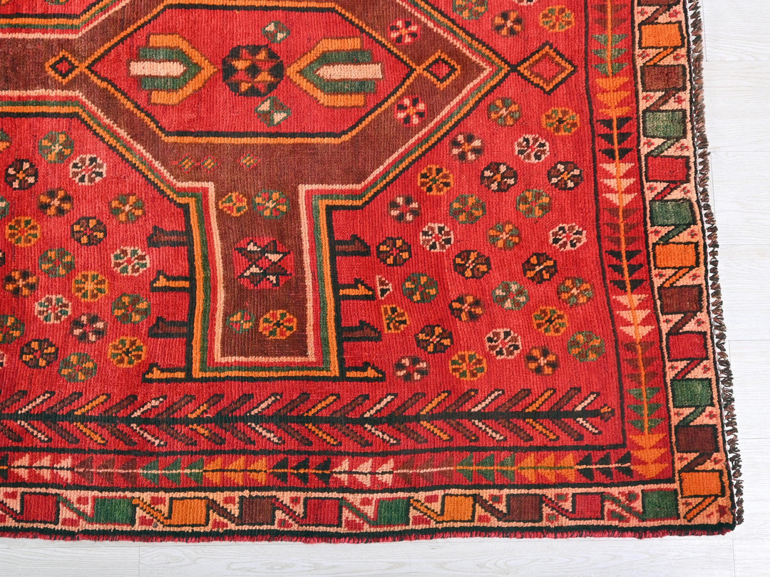 a red rug with a colorful design on it
