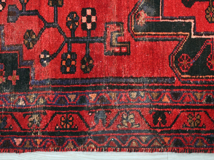 a red rug with a design on it
