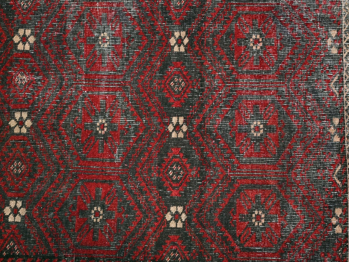 a red and black rug with a white border