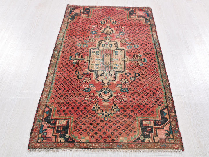 a red oriental rug on a white floor