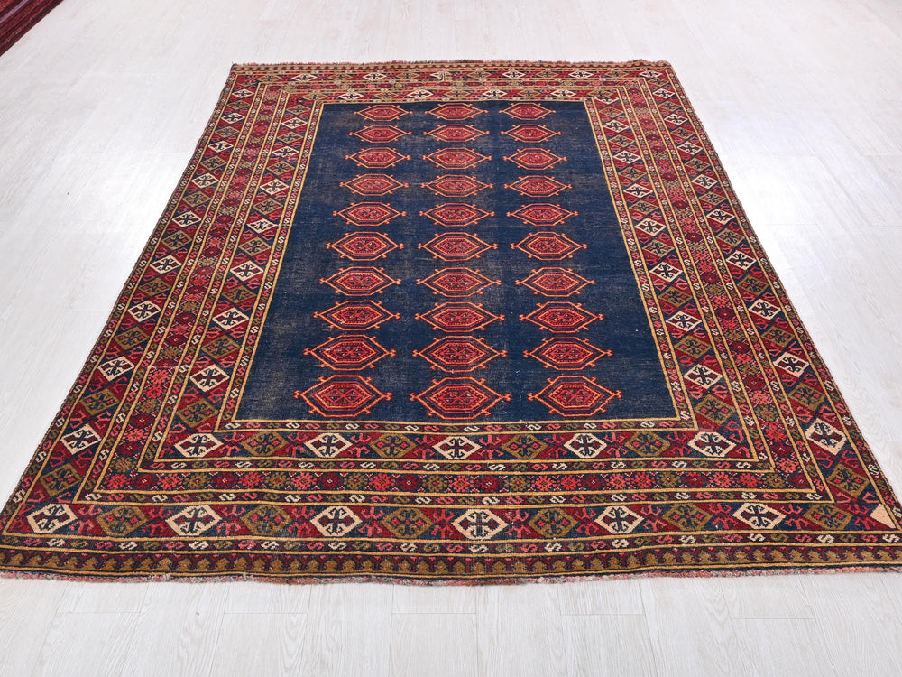 a blue and red rug on a white floor