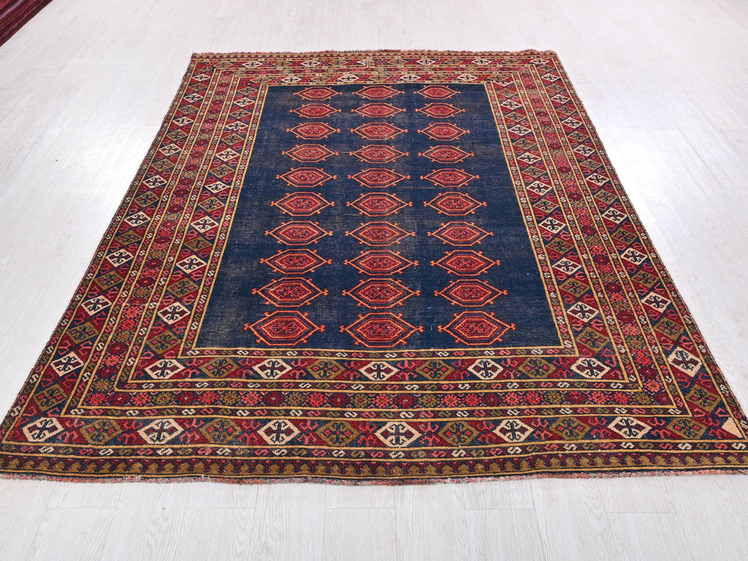 a blue and red rug on a white floor